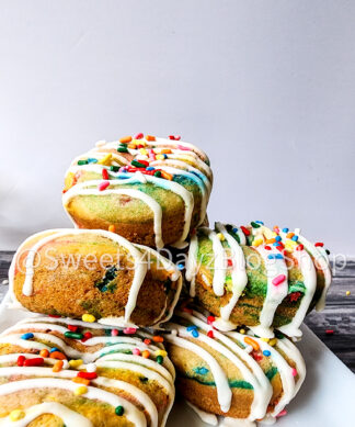 Vegan Rainbow Funfetti Donuts on Grey Wood