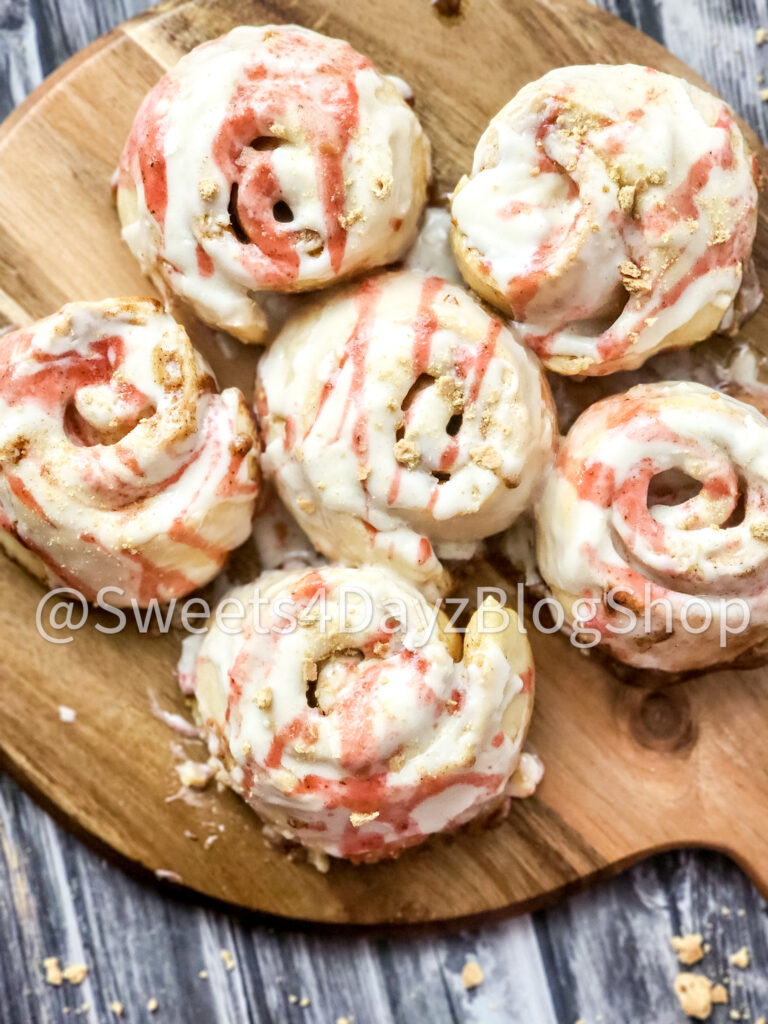 Strawberry Cheesecake Cinnamon Rolls on Grey Wood - Image 2