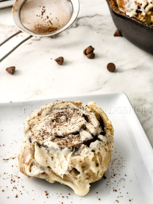 Cast Iron Chocolate Caramel Cinnamon Rolls on Marble - Image 2