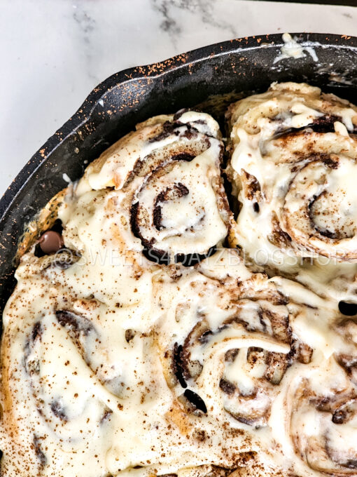 Cast Iron Chocolate Caramel Cinnamon Rolls on Marble - Image 6